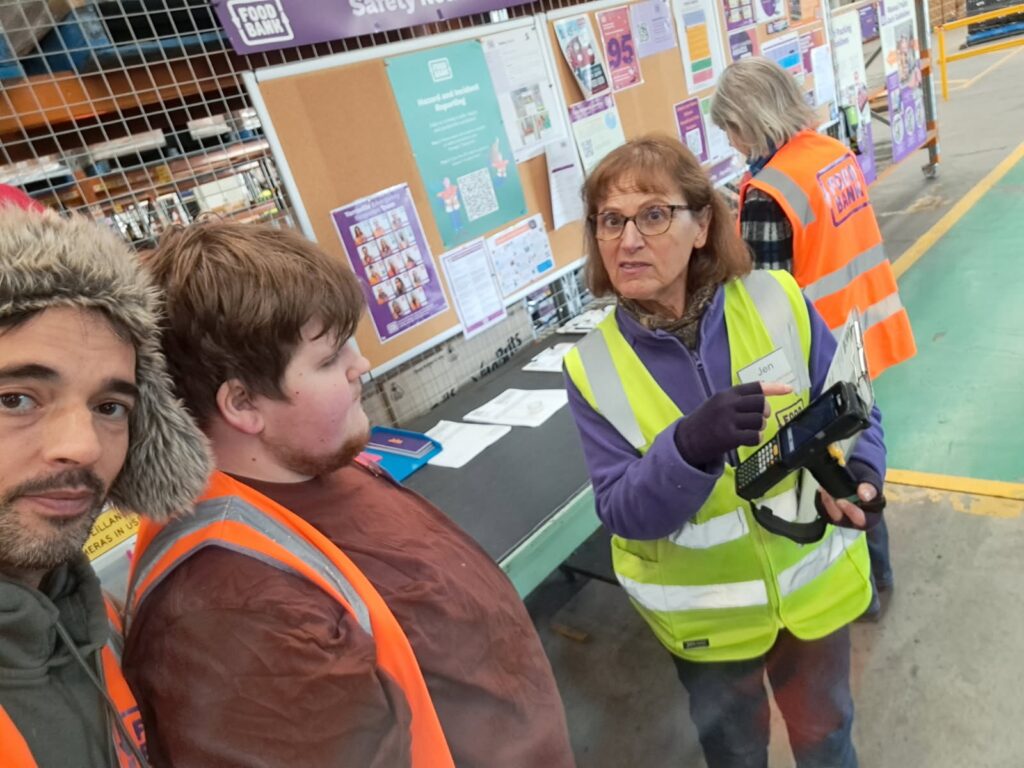 Markus Misins being showed the scanner at Foodbank
